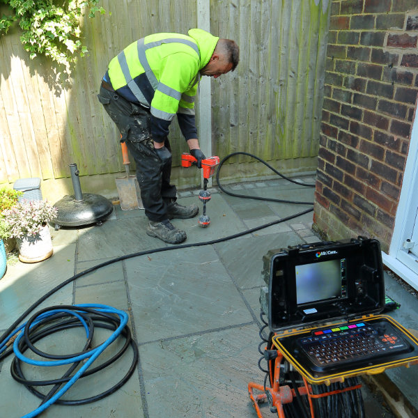 A drain consultant undertaking a non invasive drain inspection