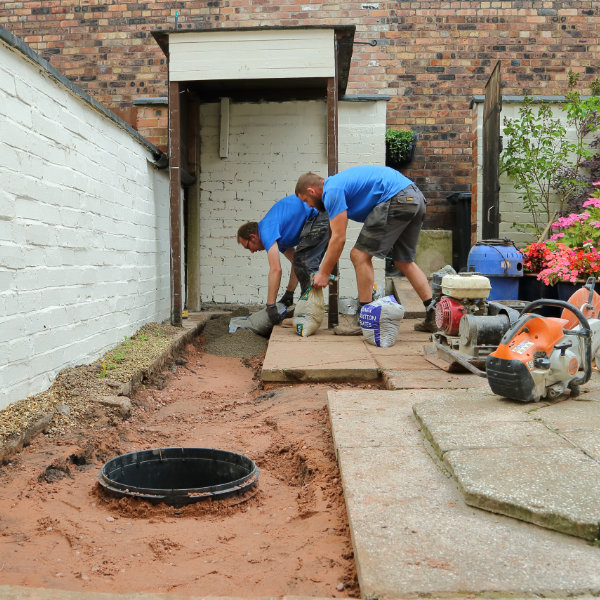 Two drain experts undertaking a drain repair project