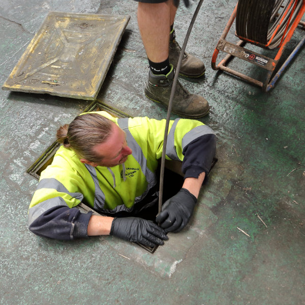 A drain unblocker working on a blocked drain