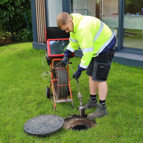 A drainage expert starting a drain inspection