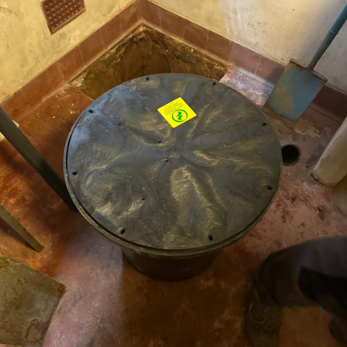 A sump pump installer part way through fitting a new sump pump